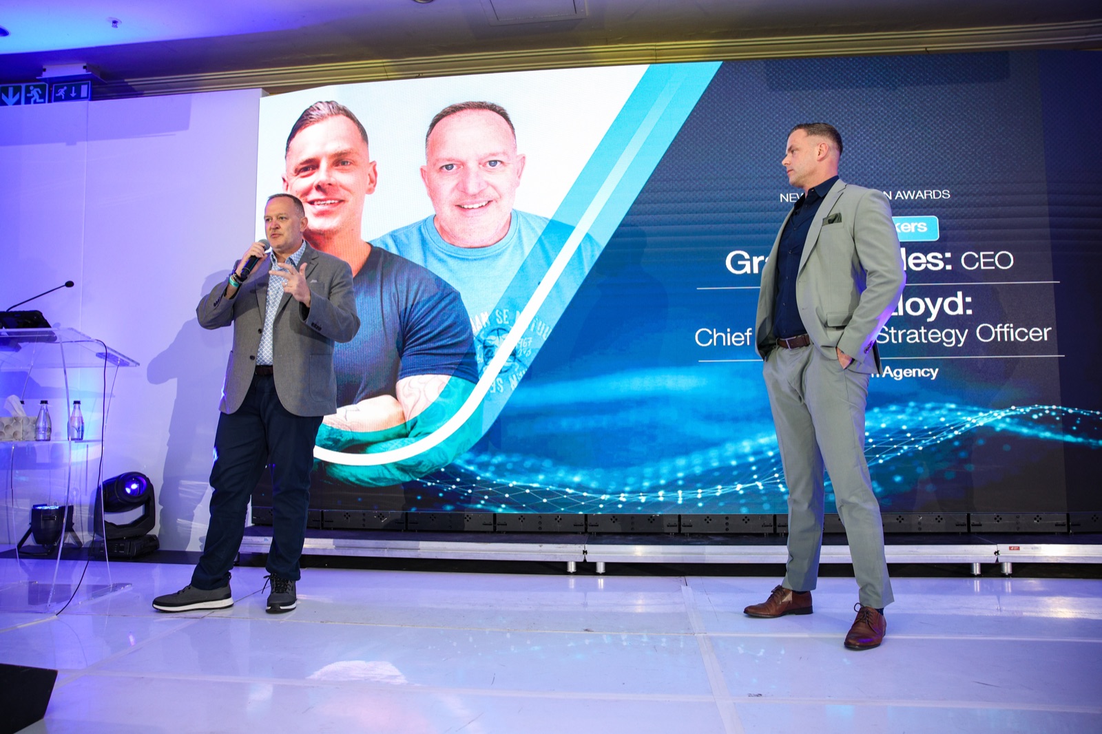 Algorithm CEO Graeme Stiles on stage at the New Generation Awards 2025, with the Algorithm Agency speaker screen visible behind him.